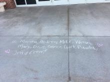 Chalk Message saying "Hi Martha, Andrew, Mike, Welles, Mary, Dave, Patrice, Kurt, Paula, Jeff and Crew" Outside of C.B. Hedgcock Building
